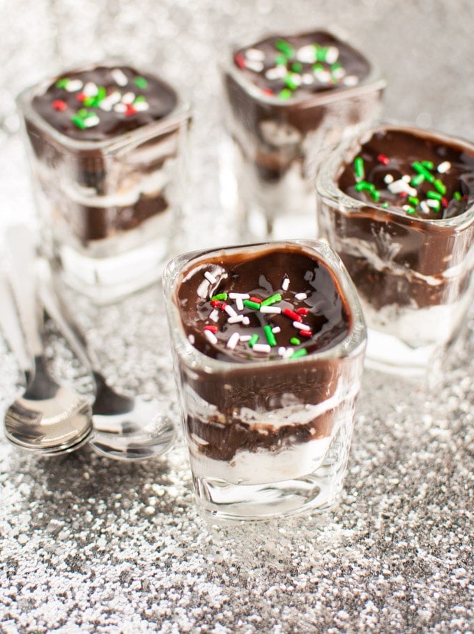 close-up of chocolate, Oreo, and Reese\'s layered pudding desserts with sprinkles