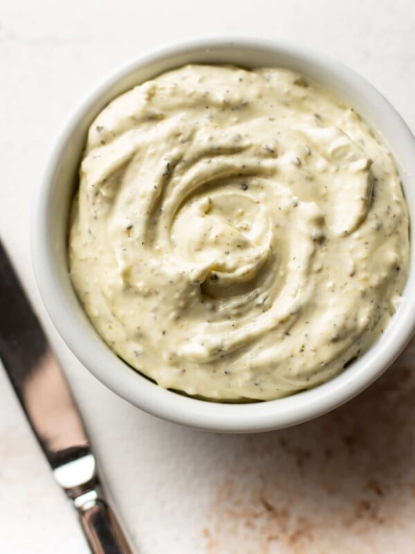 close-up of garlic herb spreadable butter in a small white bowl