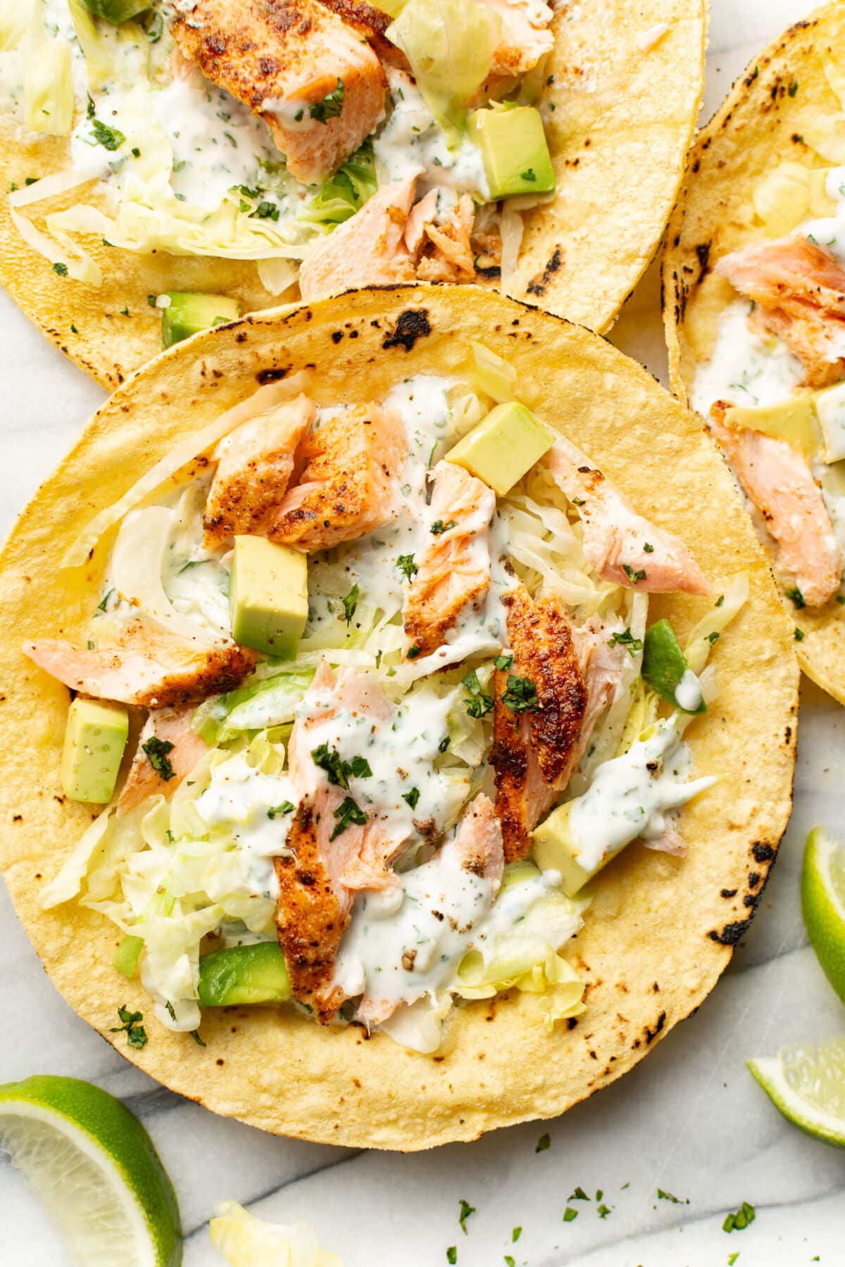 baked salmon tacos on a marble surface
