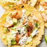 baked salmon tacos on a marble surface