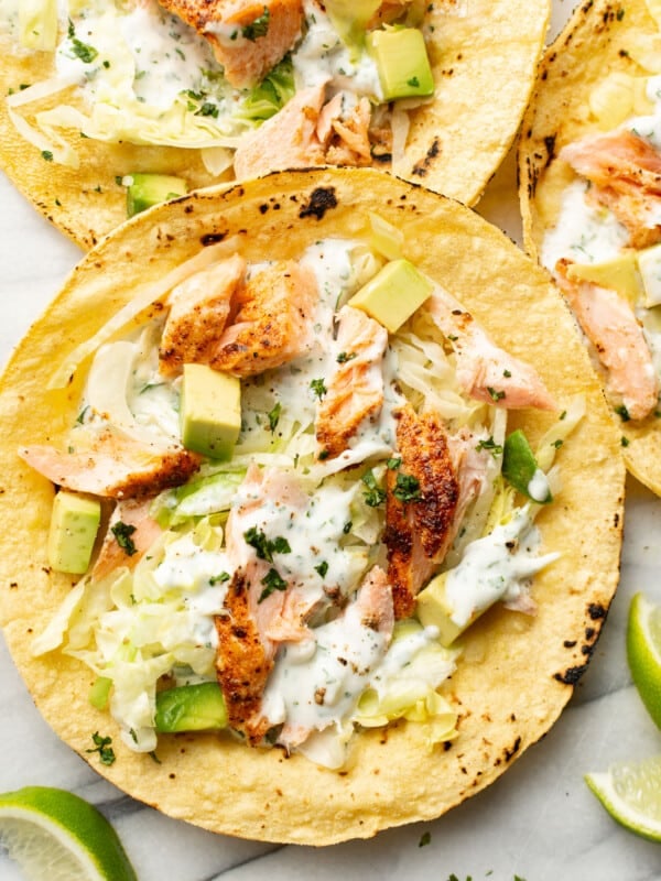 baked salmon tacos on a marble surface