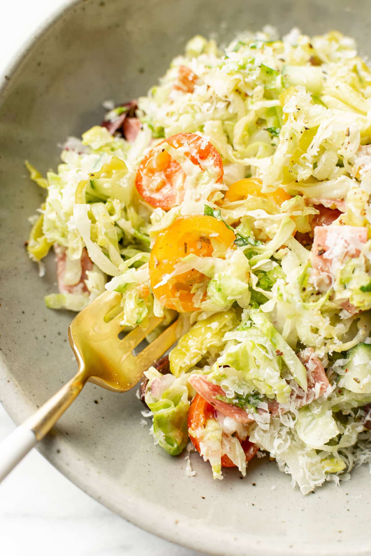a bowl of italian chopped salad with fork