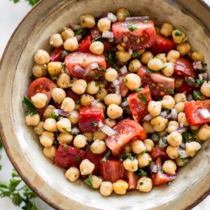 This easy vegan tomato chickpea salad recipe is healthy, delicious, and perfect for summer. You'll love the simple lemon vinaigrette. This cold chickpea salad is great for meal prep.