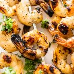 These grilled honey garlic shrimp skewers are quick, delicious, and only take 15 minutes to marinate. They're sure to be a hit this summer! 