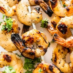 These grilled honey garlic shrimp skewers are quick, delicious, and only take 15 minutes to marinate. They're sure to be a hit this summer!