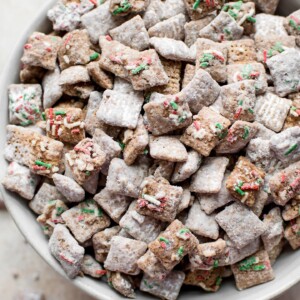 This Christmas puppy chow mix with powdered sugar, gluten-free rice Chex cereal, and plenty of sprinkles is a fun and family-friendly holiday party recipe! You won't be able to resist snacking on it.