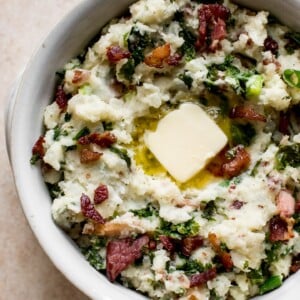 This easy colcannon recipe is a traditional Irish side dish that's a great addition to your St. Patrick's Day table. This version is with kale (or use cabbage) and bacon! Serve with plenty of butter.