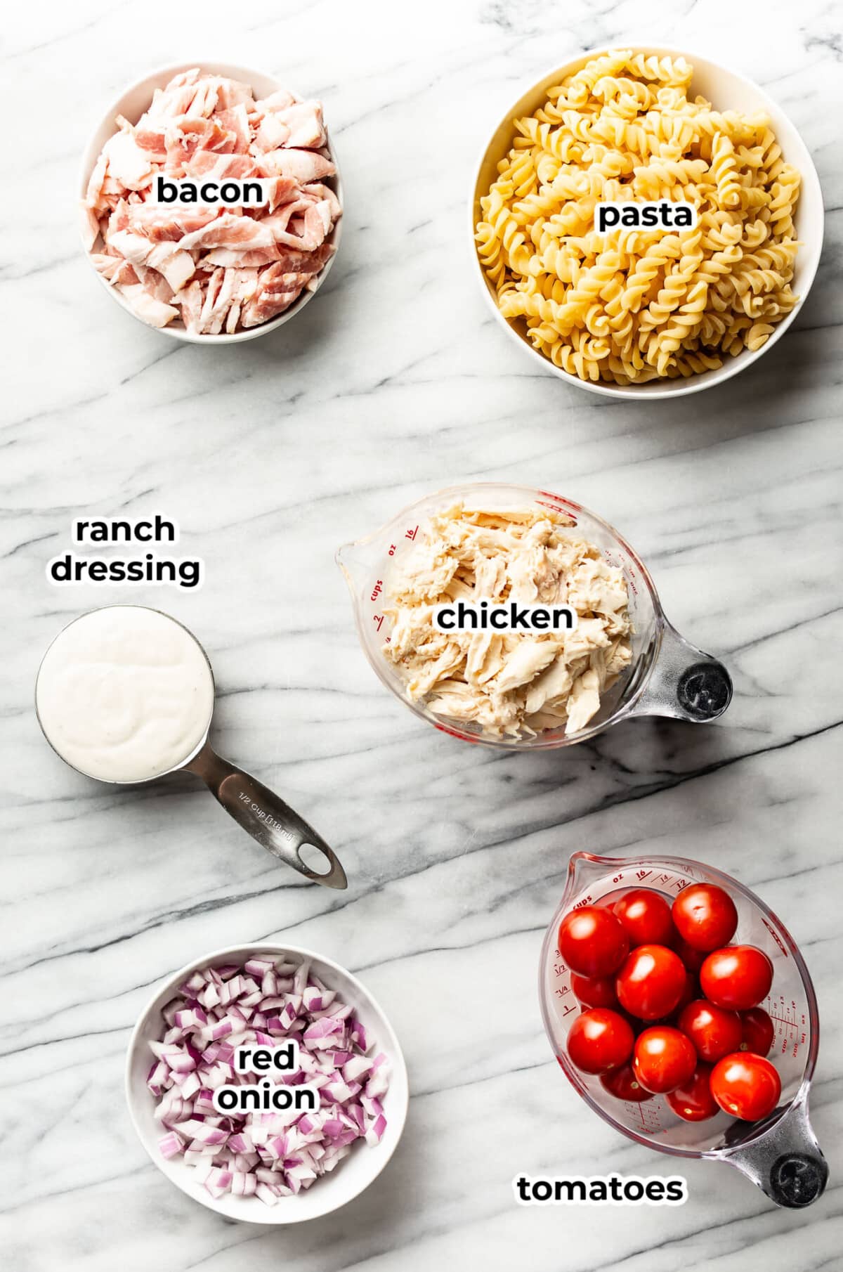 ingredients for chicken ranch pasta salad in prep bowls