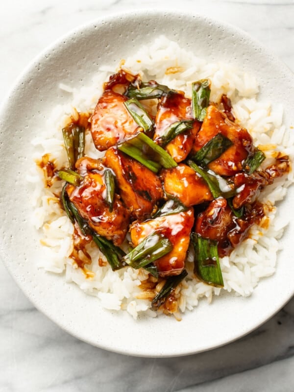 a bowl with mongolian chicken over rice