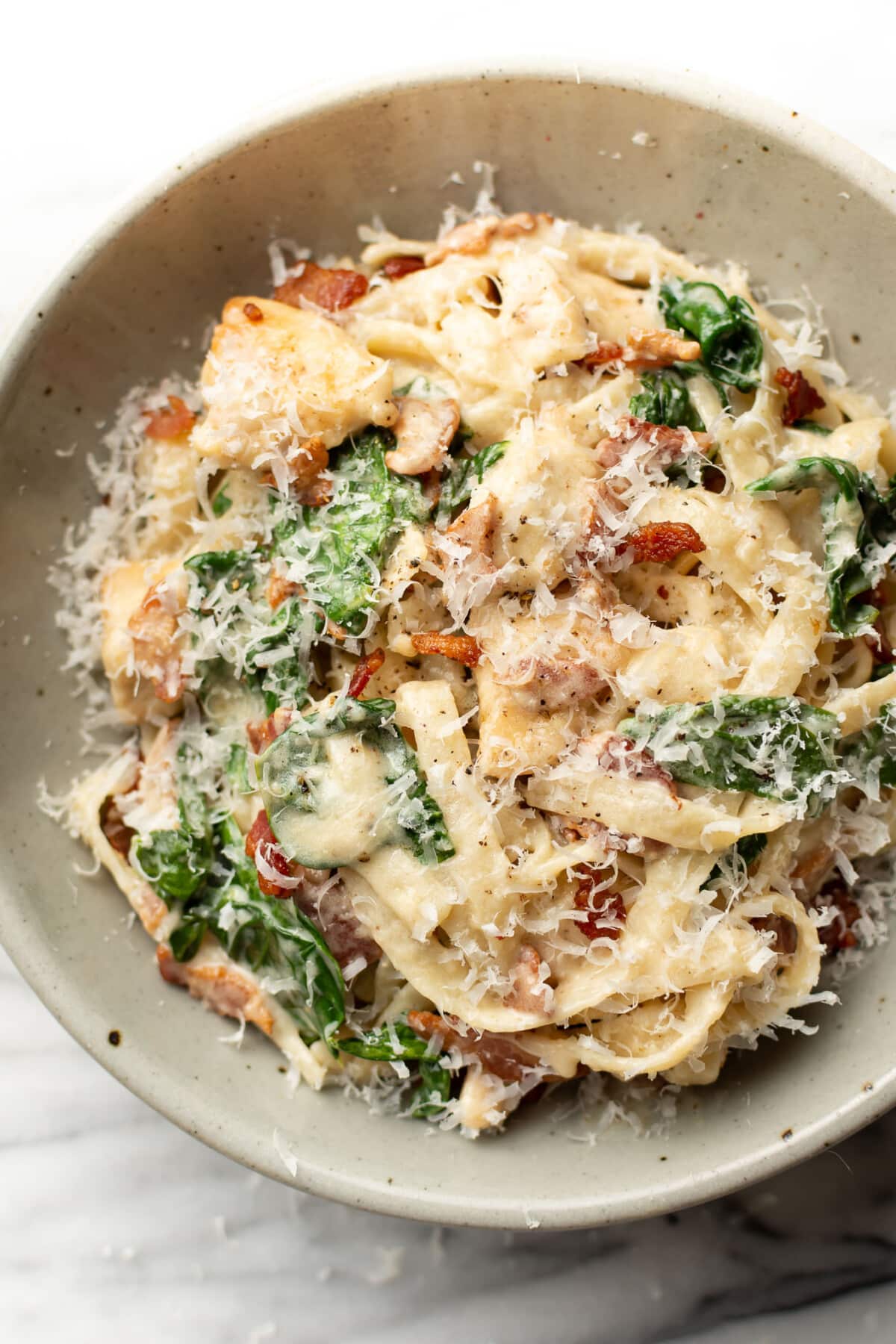 a bowl of chicken bacon spinach pasta