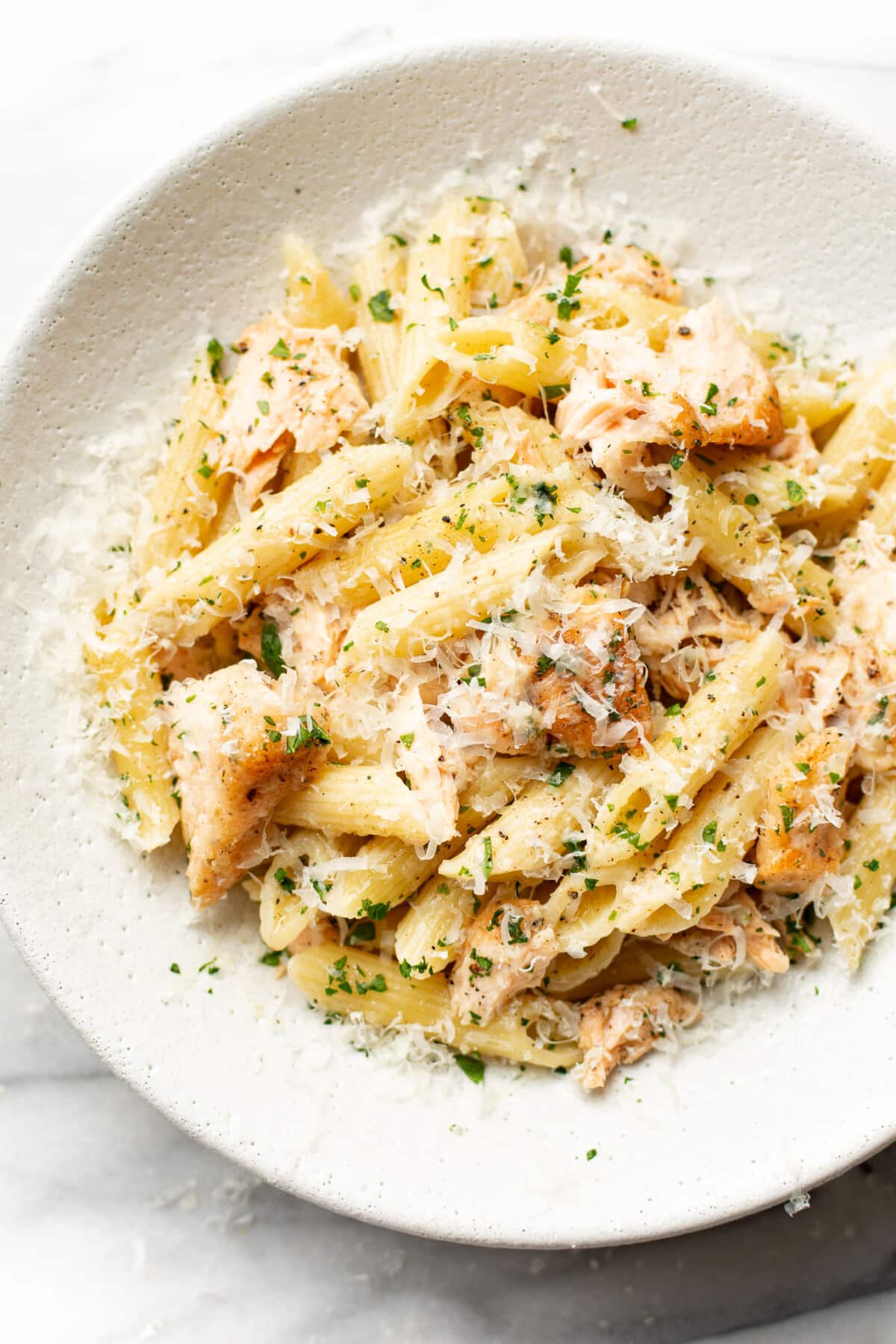 a bowl of garlic butter salmon pasta