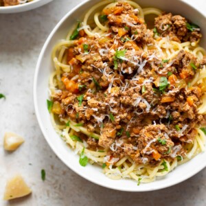 Crockpot ragu in two white bowls with spaghetti