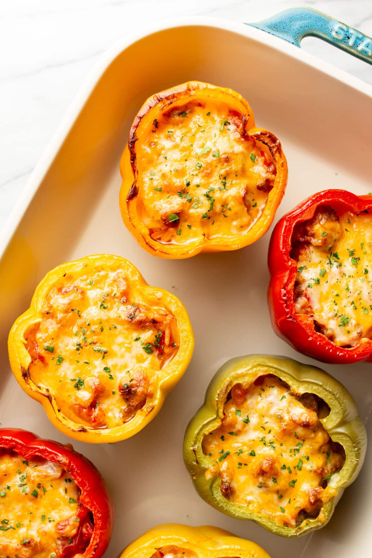 a baking dish with sausage stuffed peppers