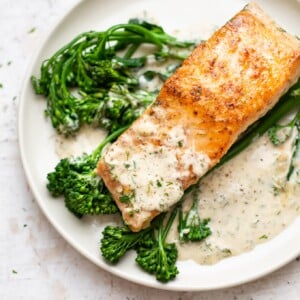 creamy dill salmon plated with broccolini and lots of sauce