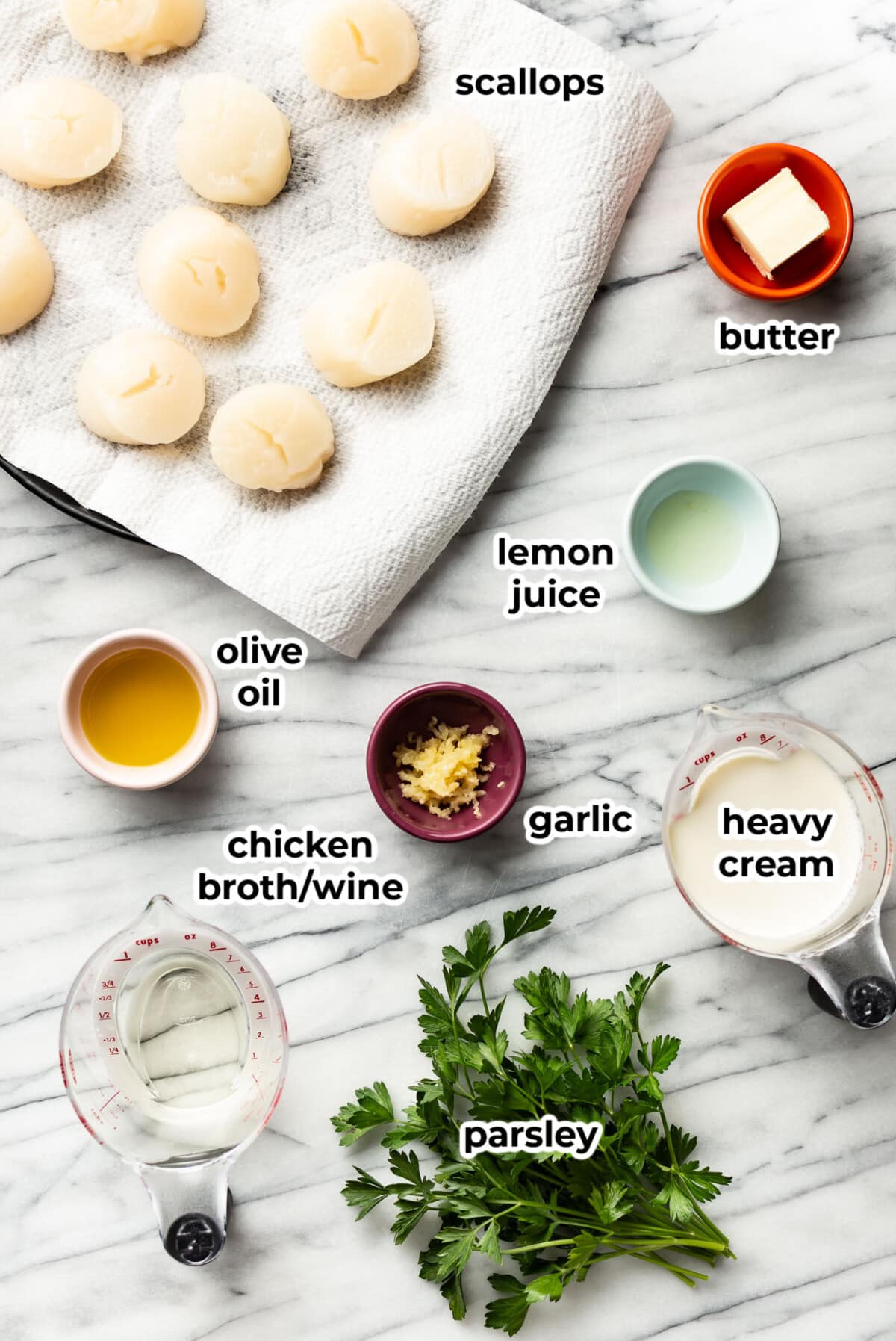ingredients for pan seared scallops in a creamy sauce in prep bowls