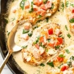 a skillet with creamy tomato basil chicken and a serving spoon