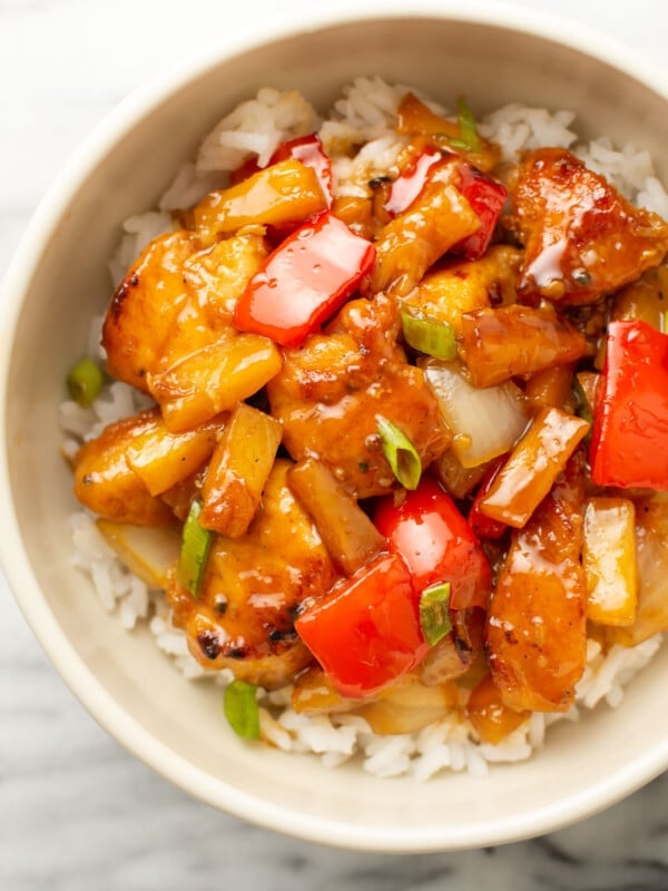 a bowl of pineapple chicken over rice