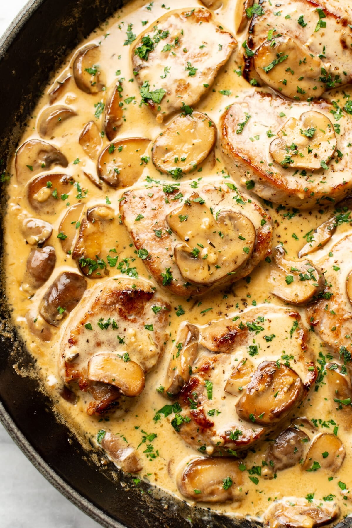 a skillet with creamy mushroom pork tenderloin