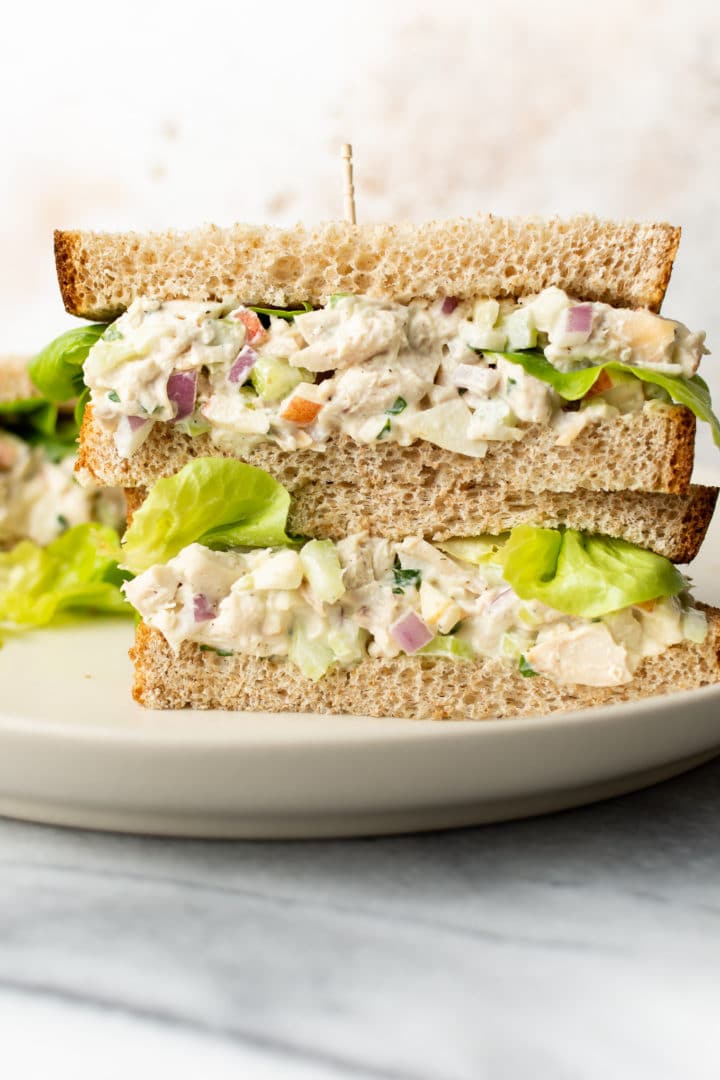 two classic chicken salad sandwiches stacked on top of each other