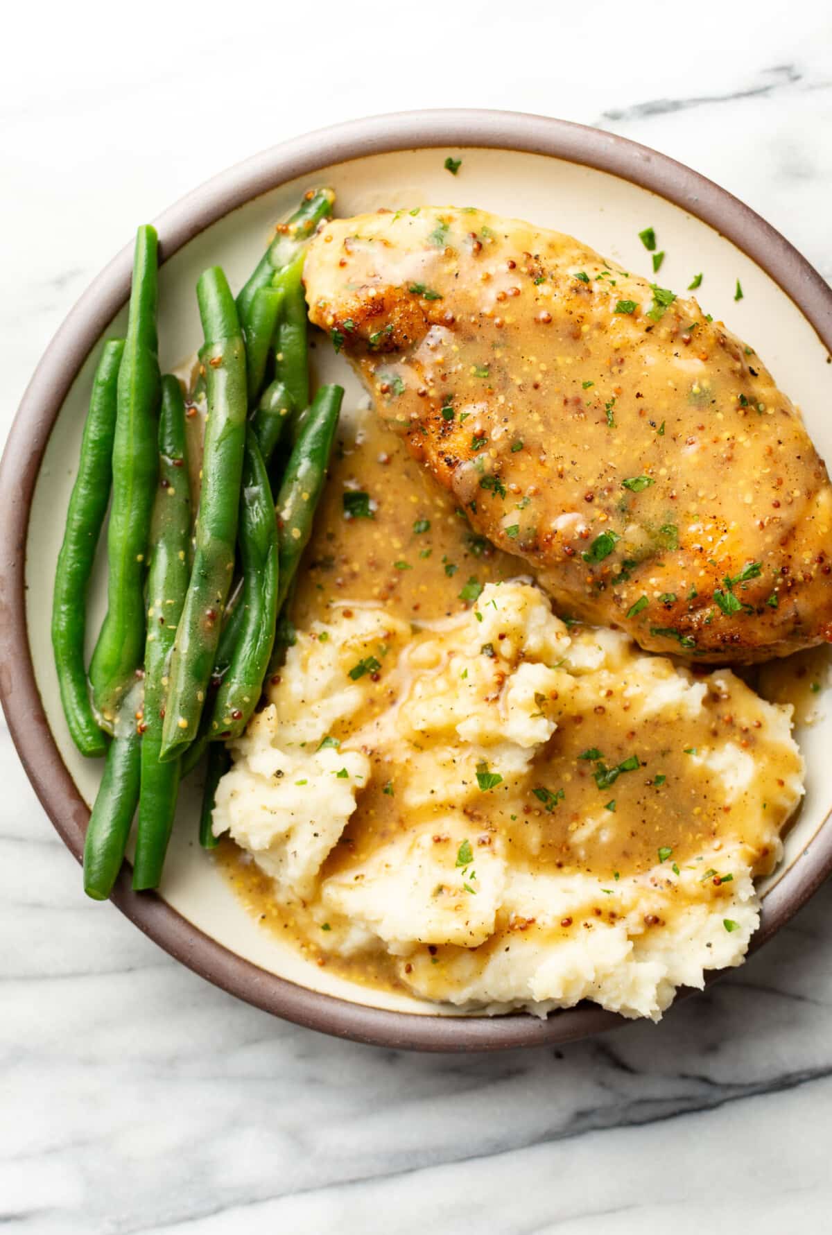 a plate with honey mustard chicken, green beans, and mashed potatoes