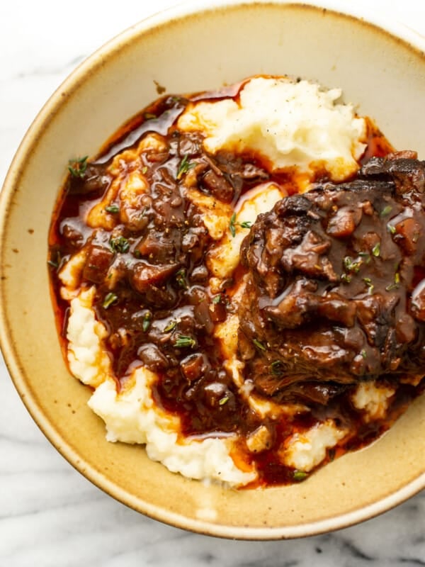 a bowl with red wine braised short ribs over mashed potatoes
