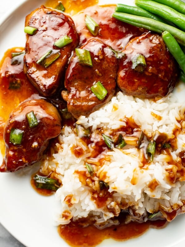 a plate with honey garlic pork tenderloin, rice, and green beans
