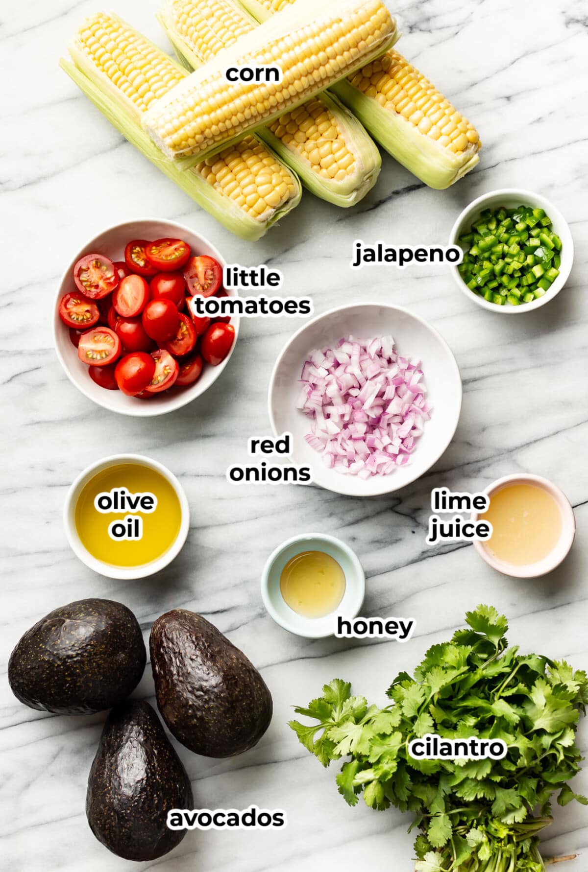 ingredients for avocado corn salad in prep bowls