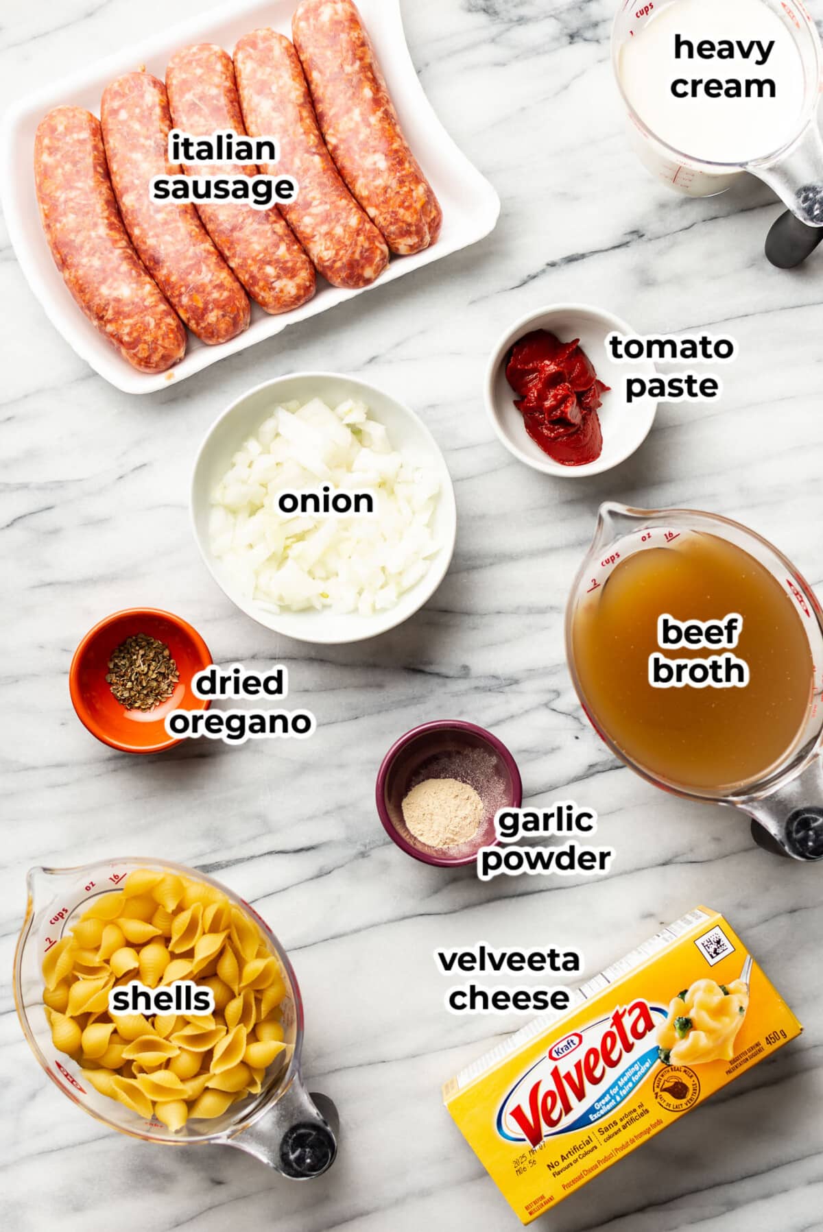 ingredients for cheesy sausage and shells in prep bowls