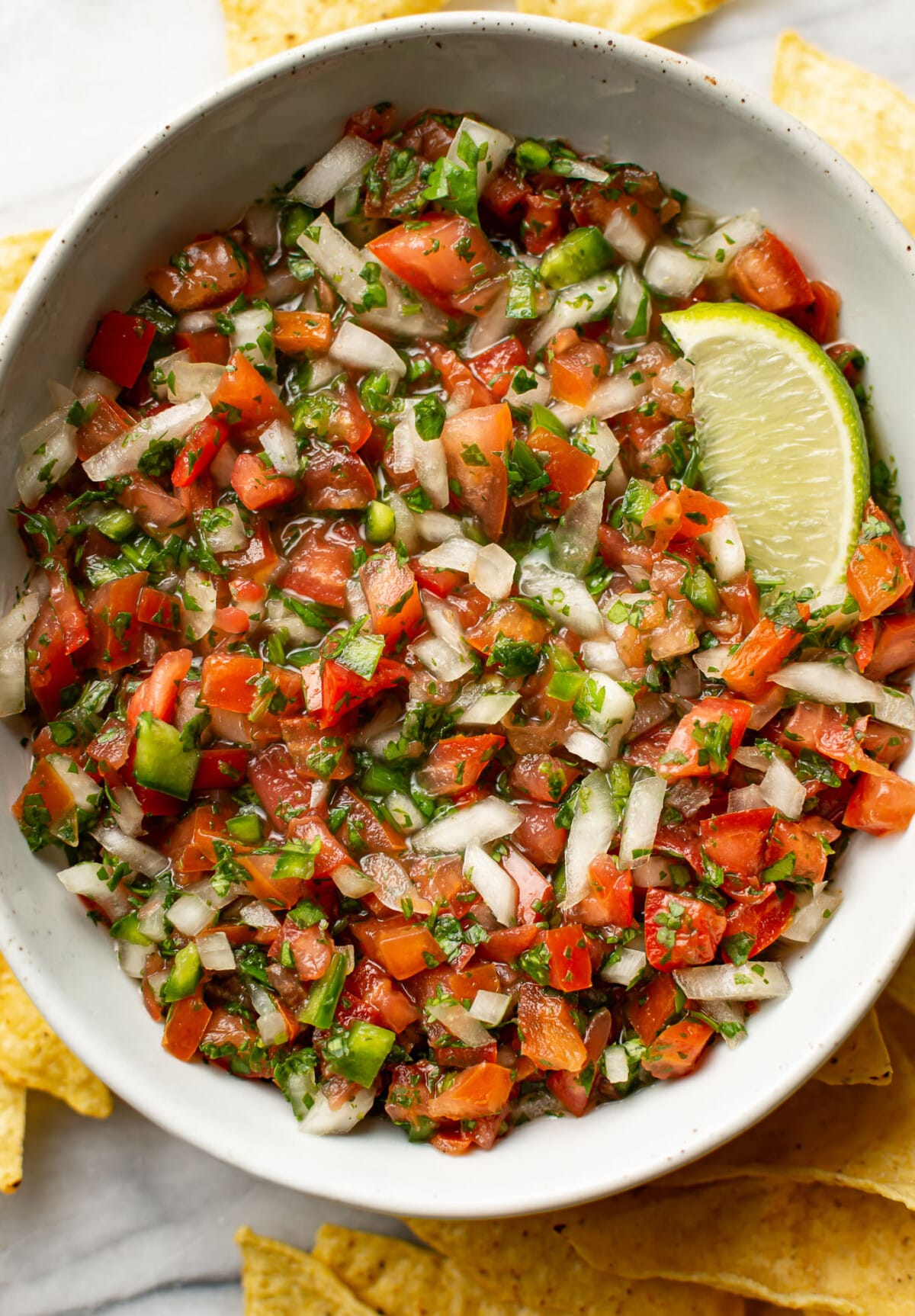 a bowl of pico de gallo with tortilla chips