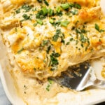 a baking dish with chicken enchiladas