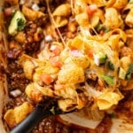 closeup of frito pie with a serving spoon