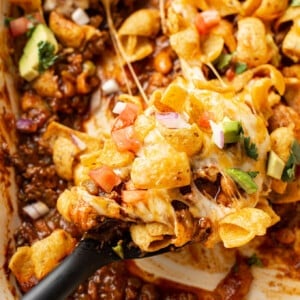 closeup of frito pie with a serving spoon