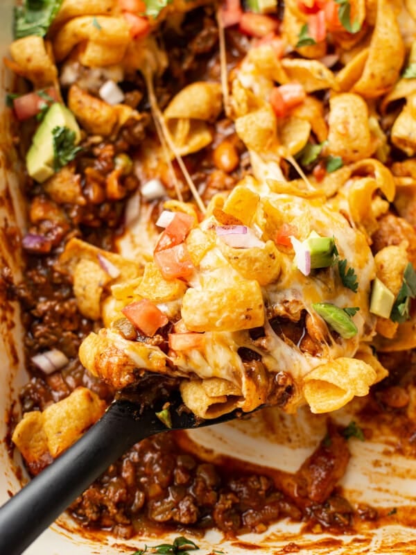closeup of frito pie with a serving spoon