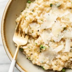 a bowl of risotto with a fork