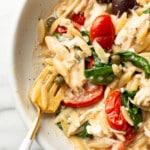 a bowl of mediterranean chicken orzo with a fork