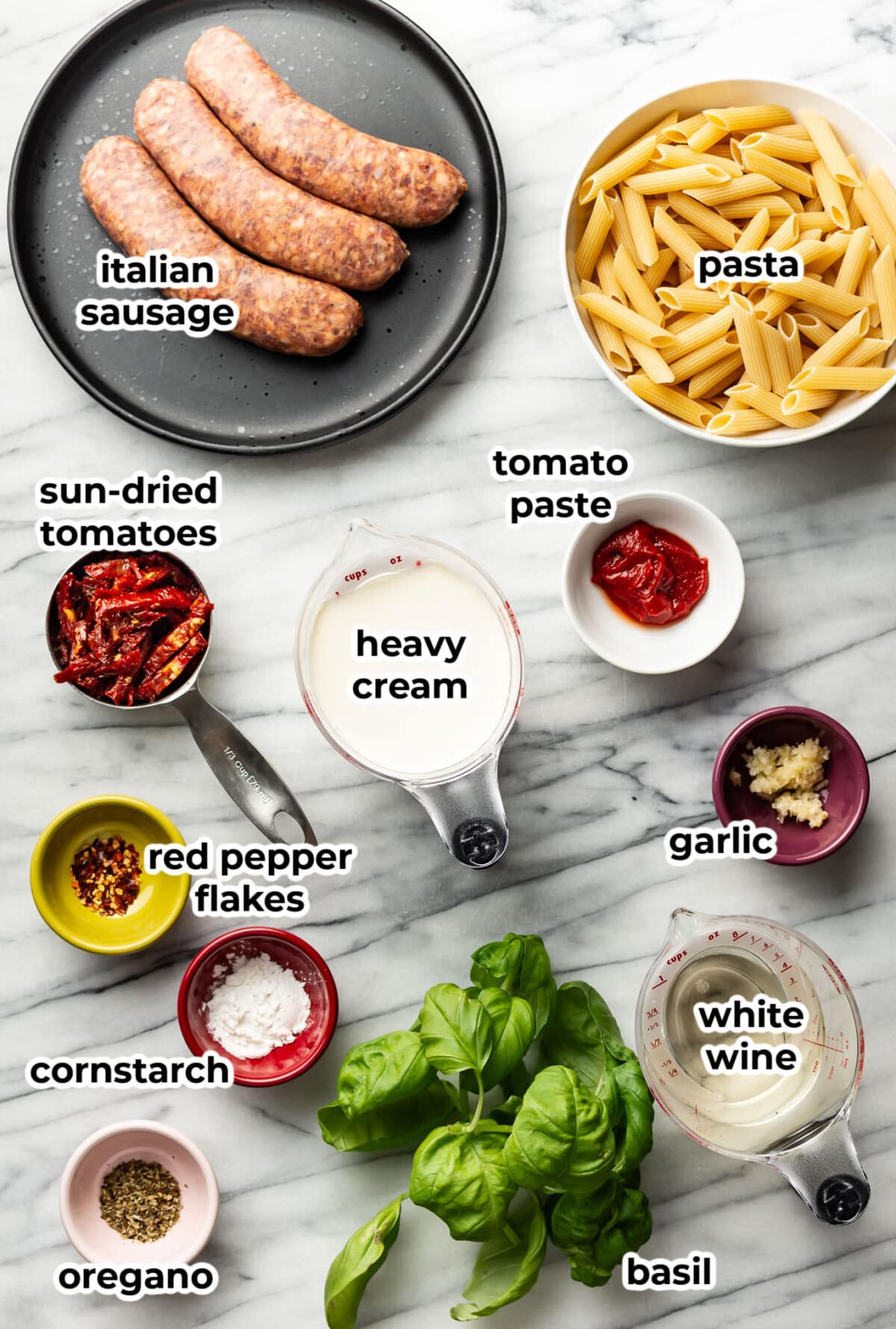 ingredients for marry me italian sausage pasta in prep bowls