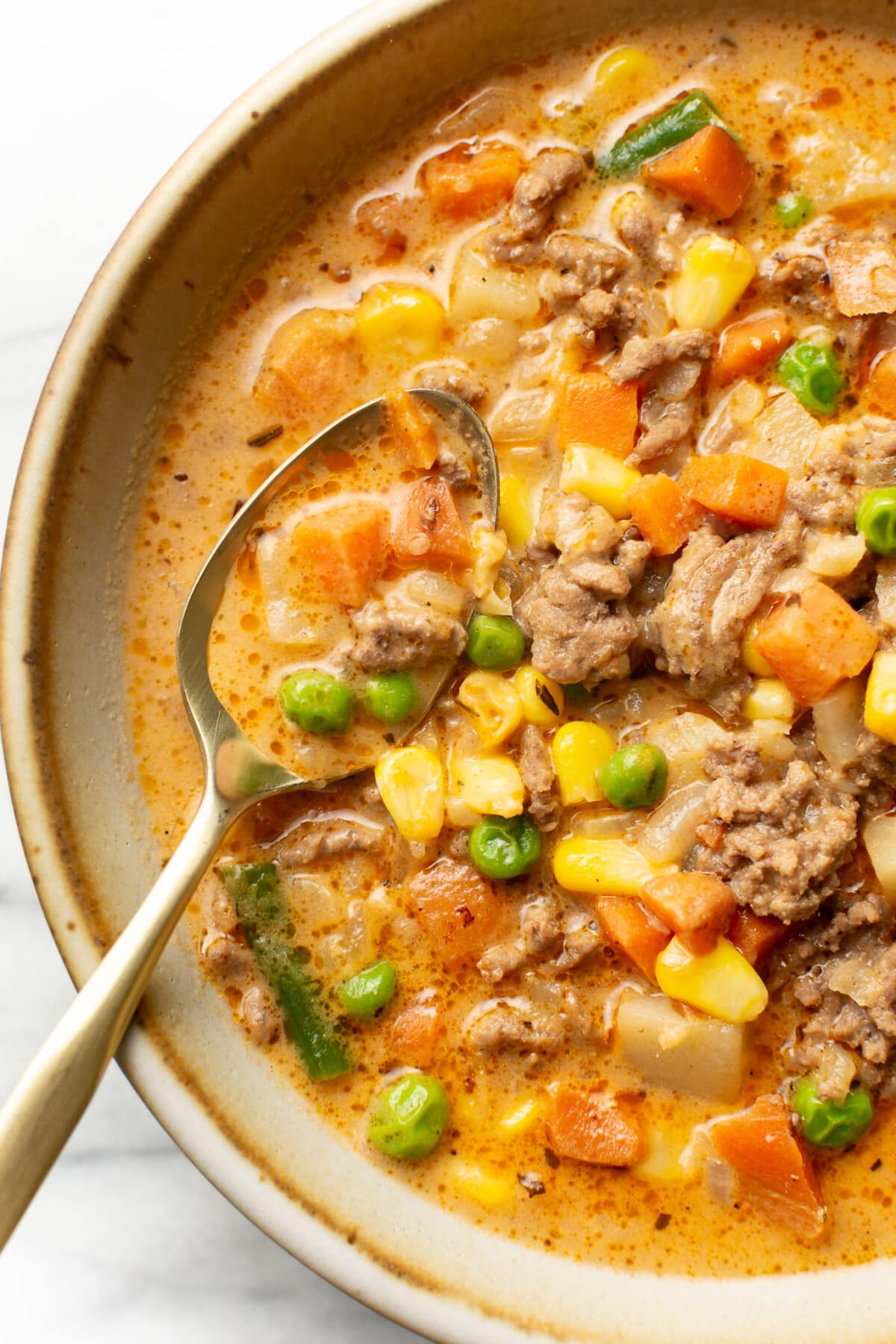 a bowl of shepherd's pie soup with a spoon