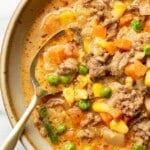 a bowl of shepherd's pie soup with a spoon