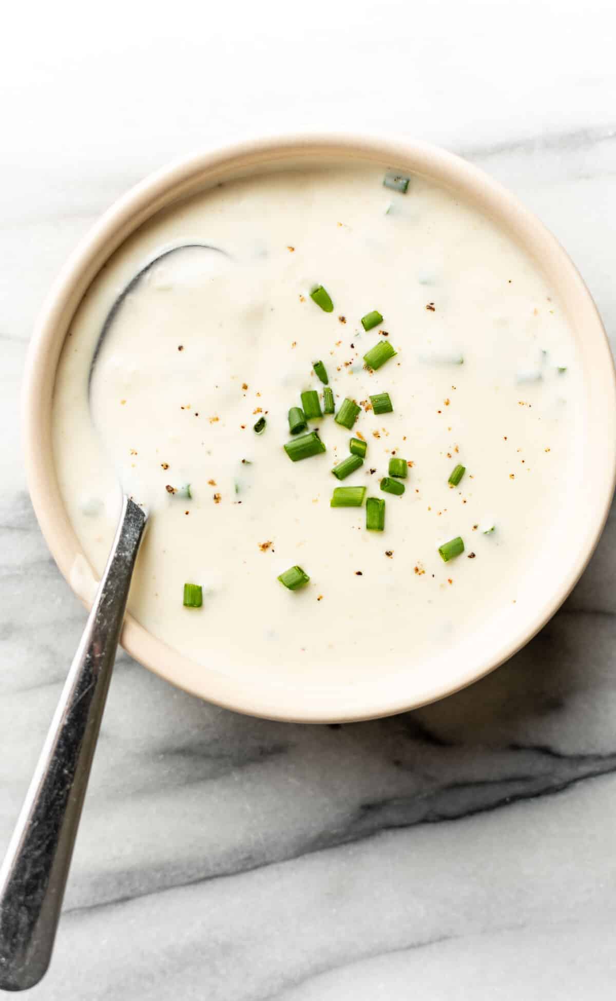 a bowl of homemade horseradish sauce with a spoon