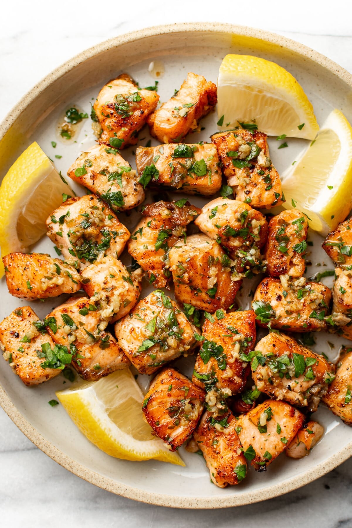 a plate with garlic butter salmon bites