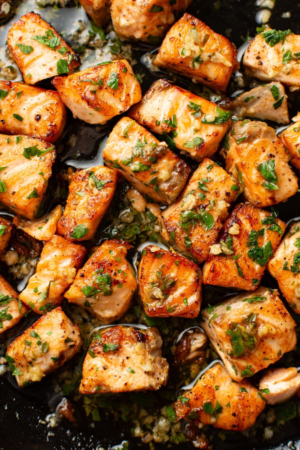 closeup of a skillet with garlic butter salmon bites