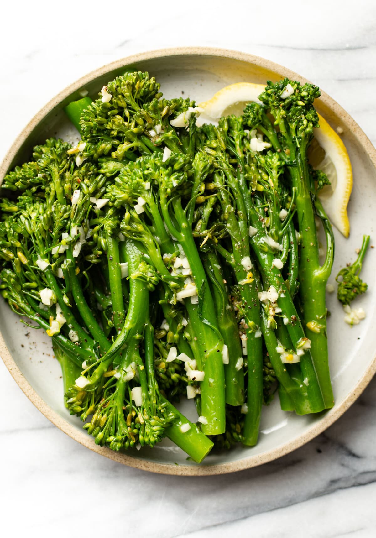 a plate with garlic butter broccolini