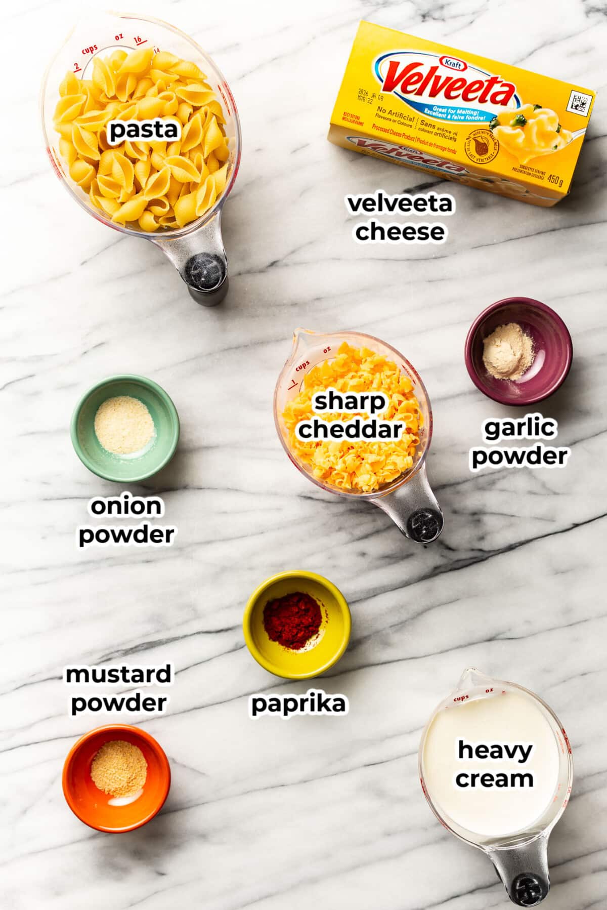 ingredients for velveeta and shells pasta in prep bowls