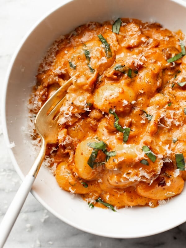 a bowl of spicy tomato gnocchi with a fork