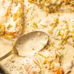 a skillet with creamy leek chicken and a serving spoon
