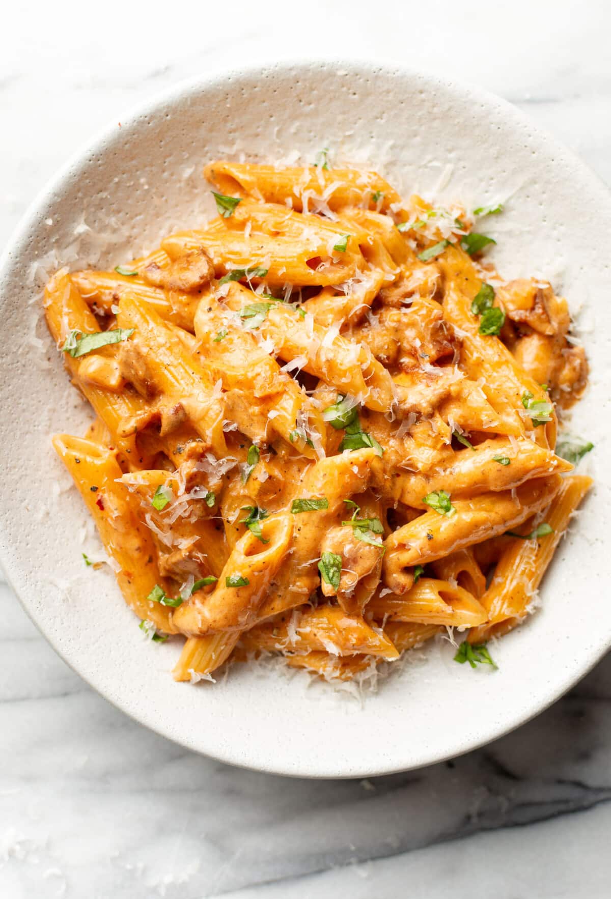 a bowl of spicy bacon tomato pasta