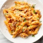 a bowl of spicy bacon tomato pasta