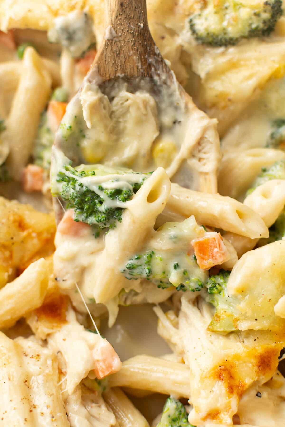 a serving spoon with chicken penne casserole