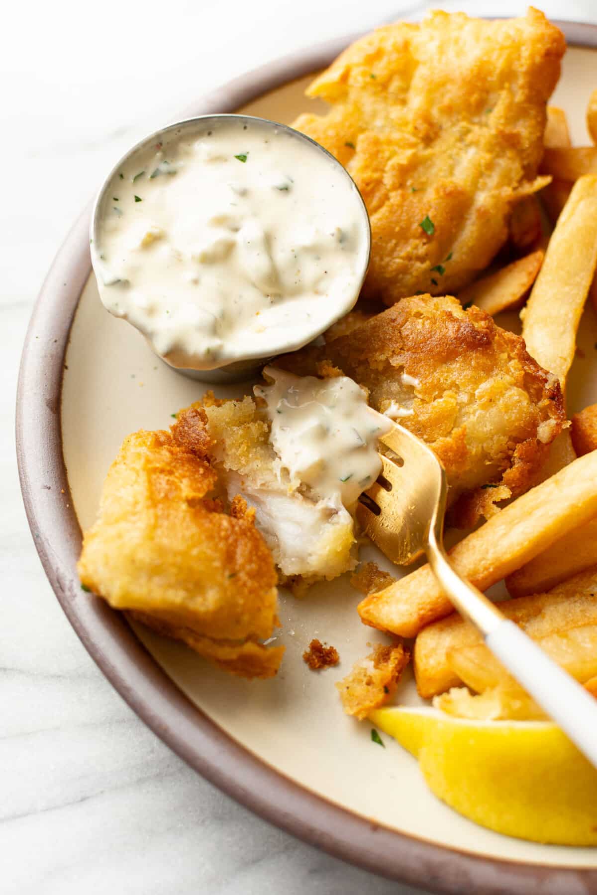 a plate with fish and chips and homemade tartar sauce