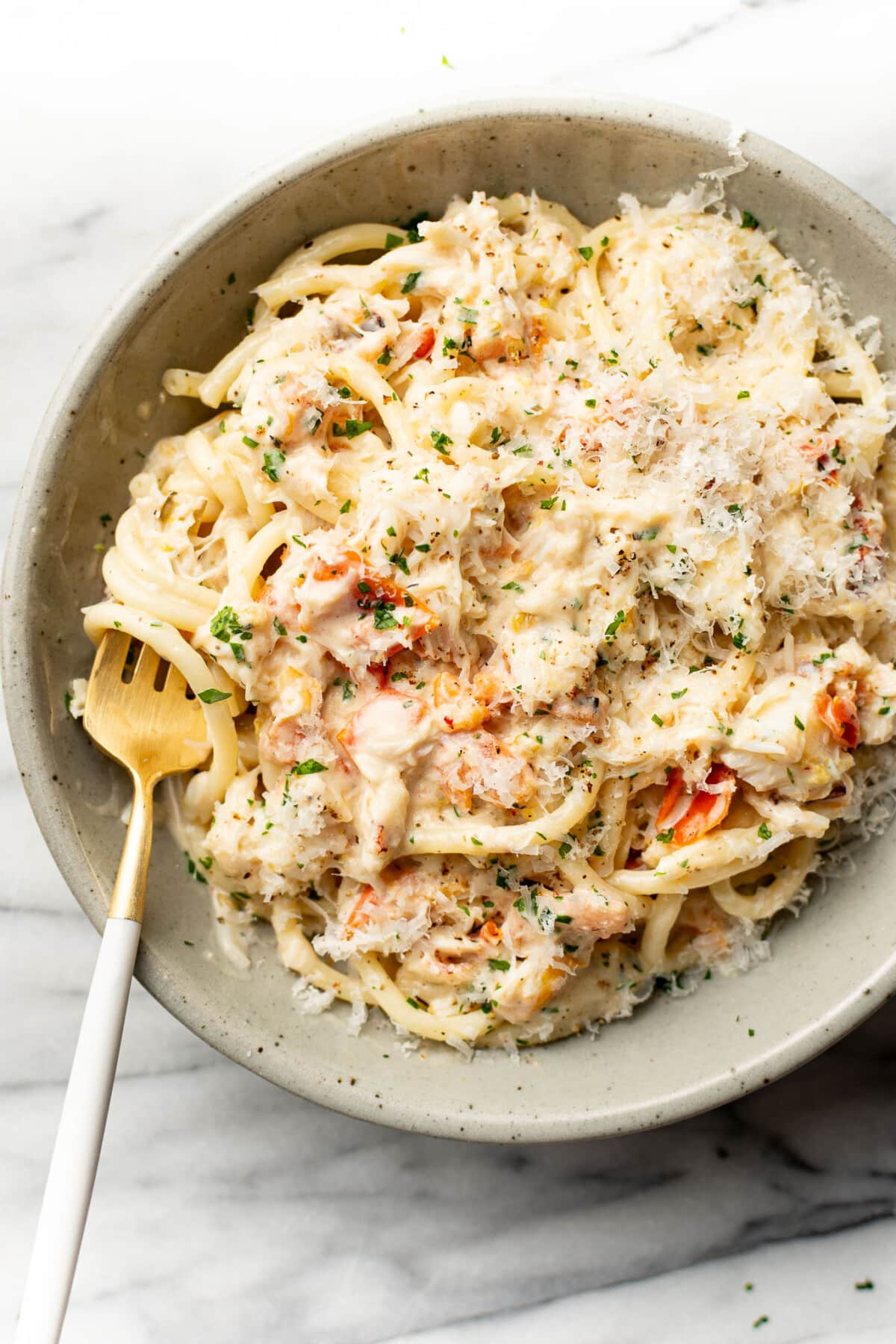 a bowl of crab pasta with a fork